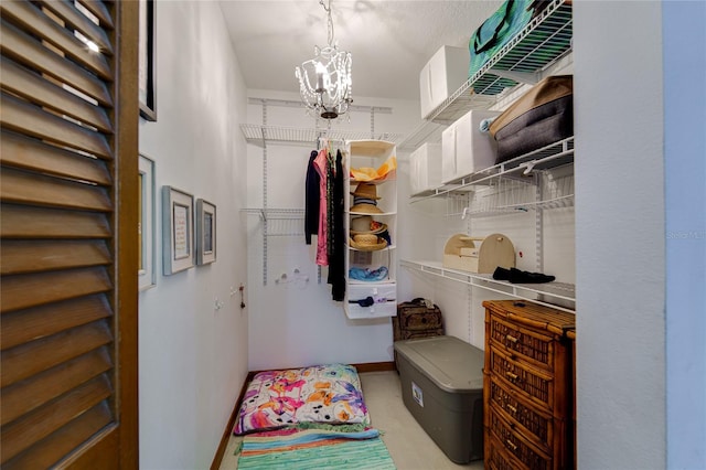 walk in closet featuring a chandelier