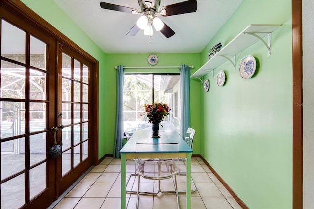 entryway featuring ceiling fan, french doors, and light tile patterned floors