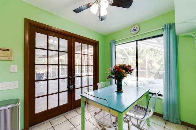 tiled dining area with ceiling fan and french doors