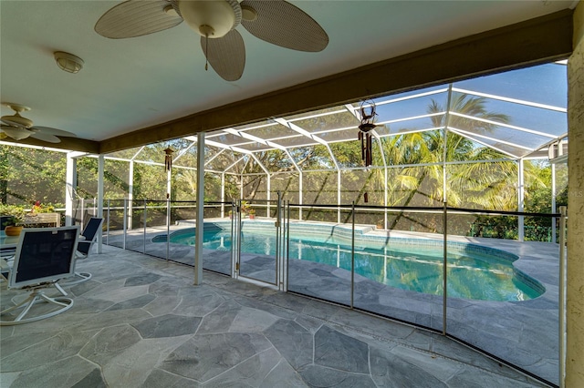 view of pool with a lanai, a patio area, and ceiling fan