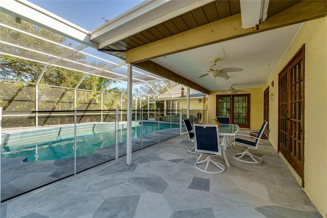 view of patio / terrace featuring glass enclosure and ceiling fan