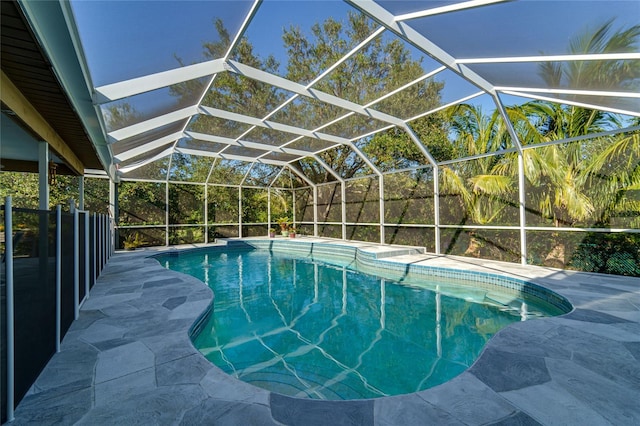 view of pool with a patio area and a lanai