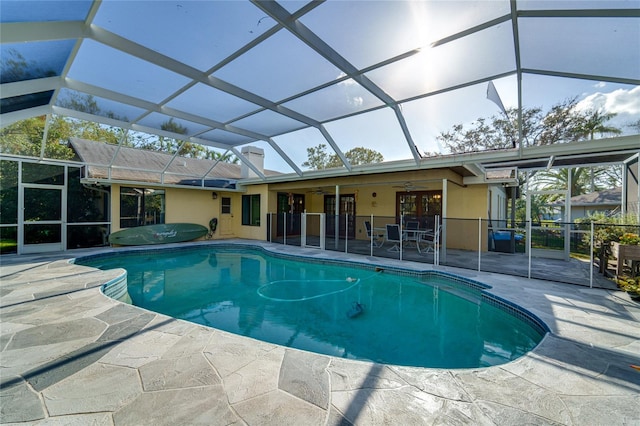 view of pool with a patio area, ceiling fan, and a lanai