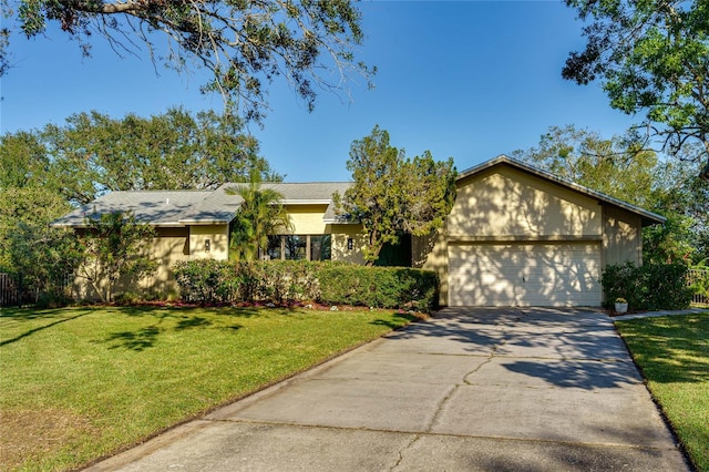 single story home with a garage and a front lawn