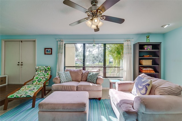 living area featuring a ceiling fan