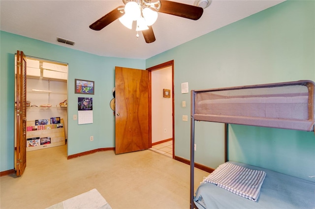 bedroom with ceiling fan, light carpet, visible vents, and baseboards