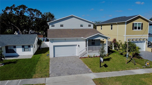 view of front of property featuring a porch, a garage, and a front lawn