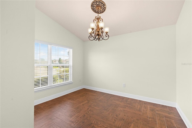 spare room with parquet flooring, an inviting chandelier, and lofted ceiling