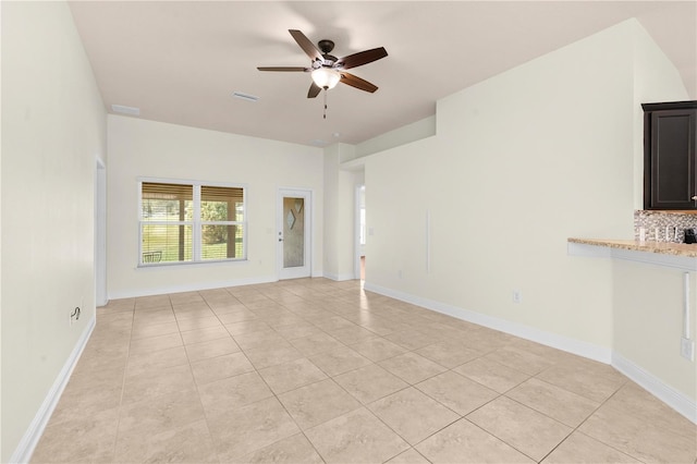 unfurnished living room with ceiling fan and light tile patterned flooring