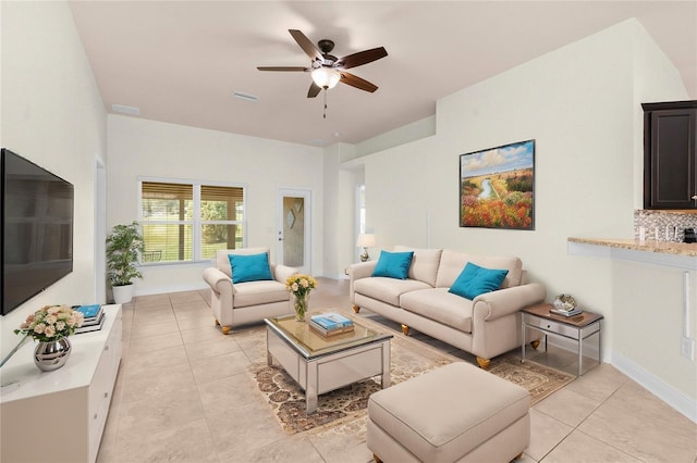 tiled living room with ceiling fan