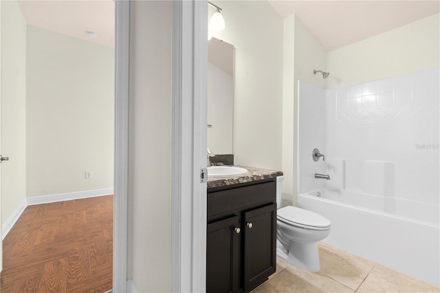 full bathroom featuring tile patterned floors, toilet, vanity, and washtub / shower combination