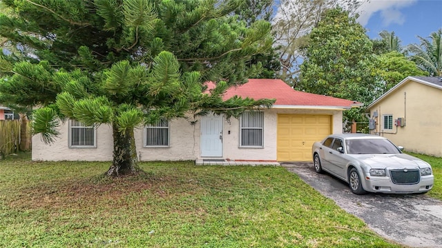 view of front of property featuring a garage and a front yard