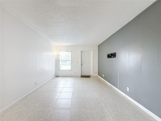 interior space featuring light tile patterned floors and a textured ceiling