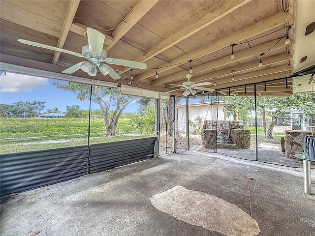 unfurnished sunroom with ceiling fan