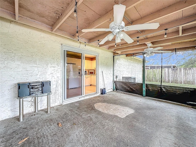 unfurnished sunroom with beam ceiling and ceiling fan