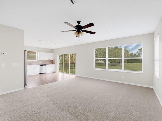 unfurnished living room with ceiling fan and light colored carpet