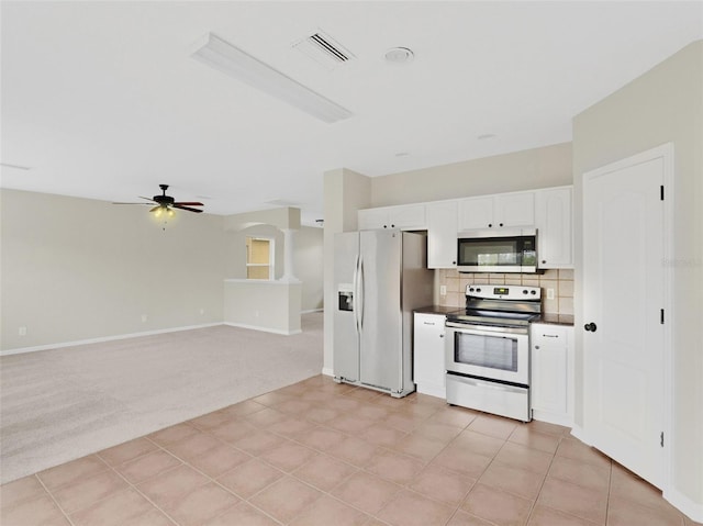 kitchen with white cabinetry, ceiling fan, stainless steel appliances, backsplash, and light carpet