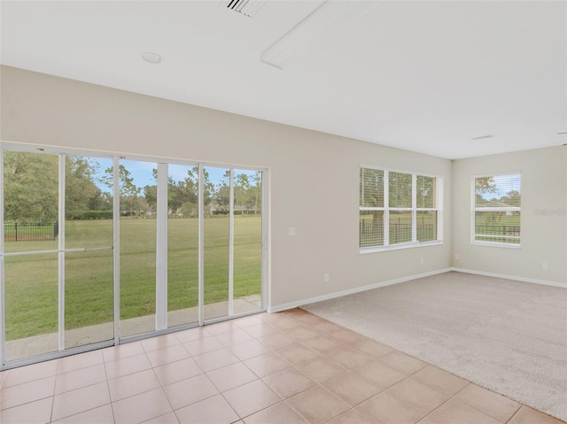 30619 White Bird Ave, Wesley Chapel, FL 33543 - spare room featuring baseboards, light carpet, and light tile patterned floors