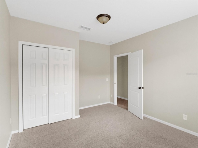 unfurnished bedroom with carpet flooring and a closet