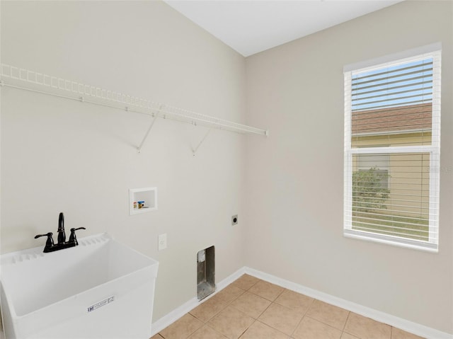 laundry room featuring electric dryer hookup, hookup for a washing machine, sink, and light tile patterned flooring