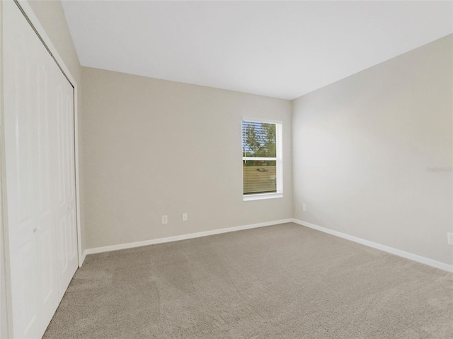 unfurnished bedroom featuring a closet and carpet floors