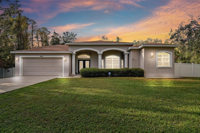 view of front of home featuring a lawn and a garage