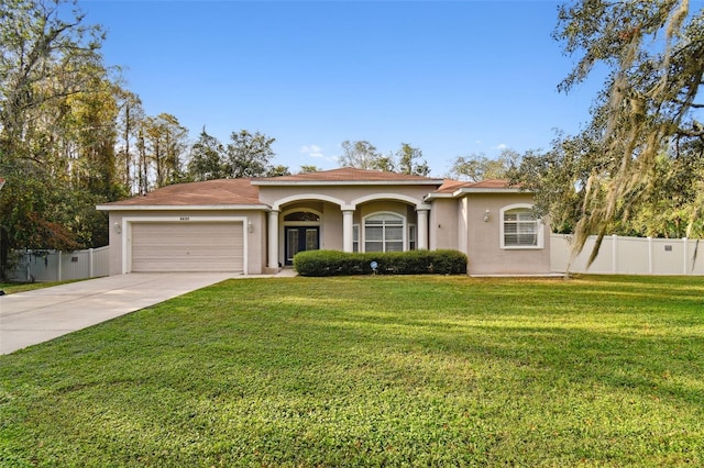 view of front of home with a front yard and a garage