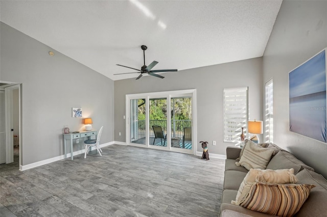 living room featuring ceiling fan, light wood-type flooring, a textured ceiling, and high vaulted ceiling