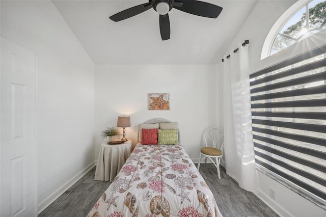 bedroom with dark hardwood / wood-style floors, vaulted ceiling, and ceiling fan