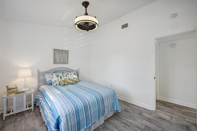 bedroom with dark hardwood / wood-style flooring