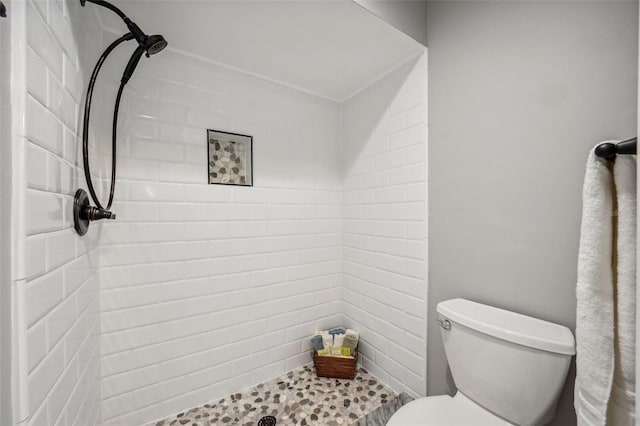 bathroom with tiled shower and toilet