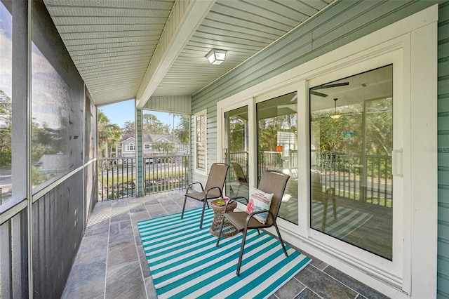 unfurnished sunroom with beamed ceiling