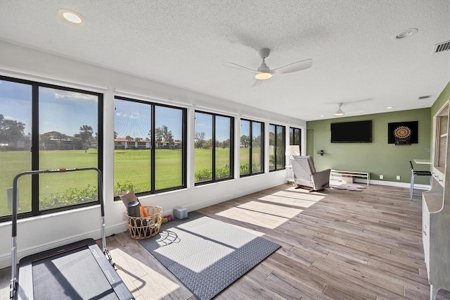 sunroom with a wealth of natural light and ceiling fan