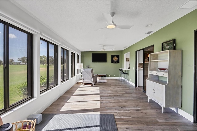 sunroom / solarium with ceiling fan