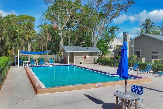 view of pool with an outbuilding and a patio area