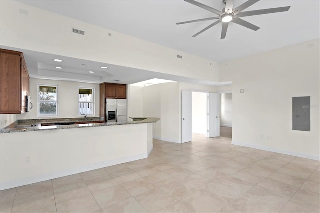 450 Knights Run Ave Unit 407, Tampa, FL 33602 - kitchen featuring stainless steel fridge, electric panel, open floor plan, a ceiling fan, and dark stone countertops