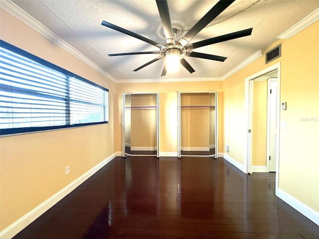 unfurnished bedroom featuring a textured ceiling, wood-type flooring, and visible vents