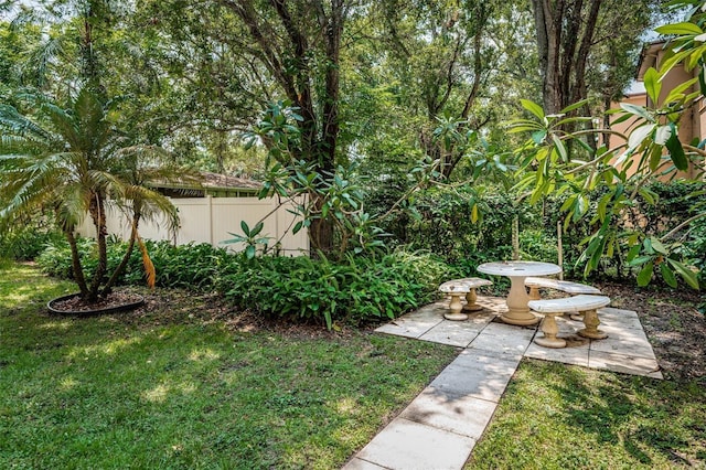 view of yard featuring fence and a patio