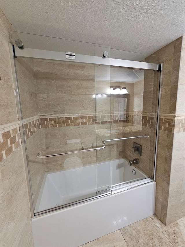 full bath with a textured ceiling and shower / bath combination with glass door