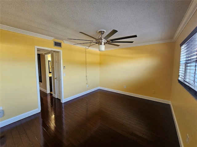 empty room featuring dark wood-type flooring, visible vents, crown molding, and baseboards