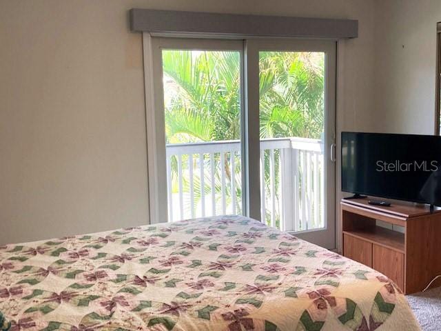 carpeted bedroom featuring multiple windows