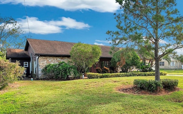 ranch-style home featuring a front yard