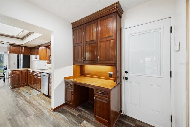 kitchen featuring dishwasher, dark hardwood / wood-style flooring, and sink