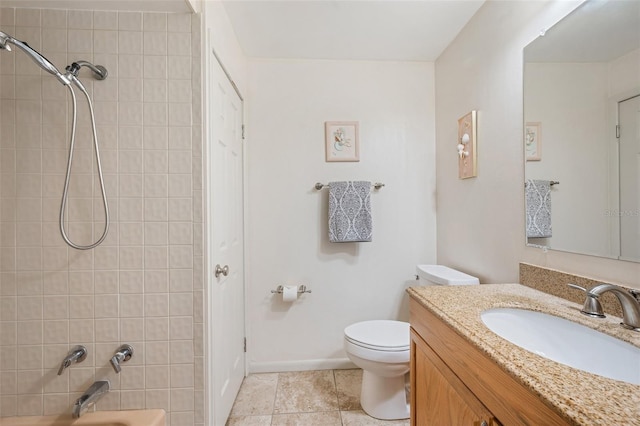 full bathroom with vanity, tiled shower / bath combo, and toilet