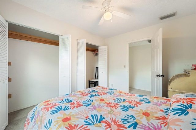 bedroom featuring ceiling fan, carpet floors, and a textured ceiling