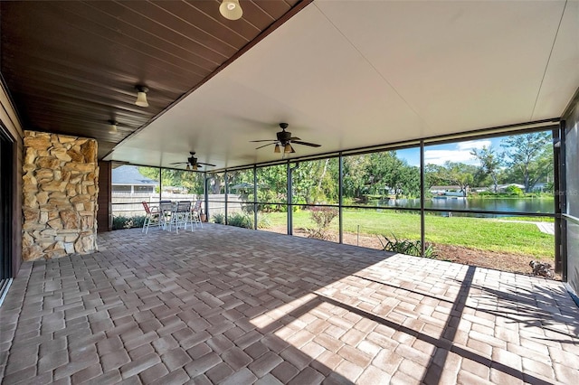 unfurnished sunroom featuring a water view and lofted ceiling