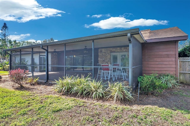 view of property exterior featuring ceiling fan and a sunroom