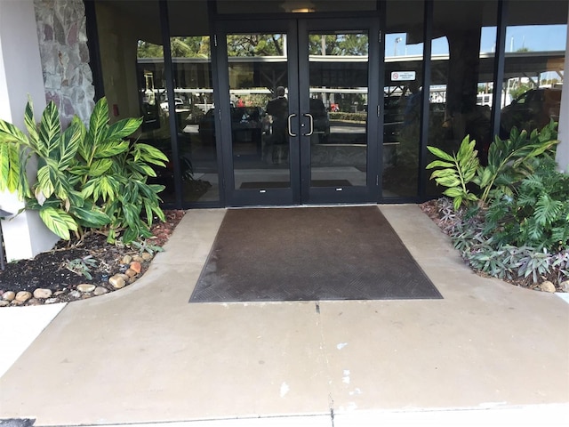 632 Edgewater Dr Unit 532, Dunedin, FL 34698 - view of exterior entry featuring french doors and stone siding