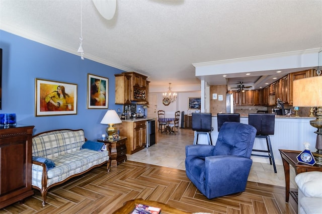632 Edgewater Dr Unit 532, Dunedin, FL 34698 - living room with ceiling fan, a chandelier, a textured ceiling, and ornamental molding