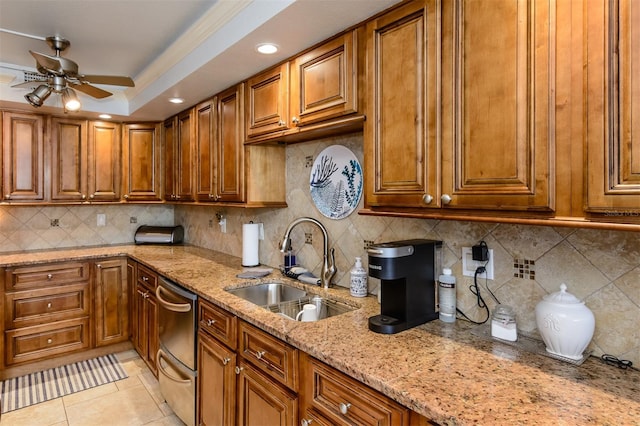 kitchen with sink, stainless steel dishwasher, decorative backsplash, light stone countertops, and light tile patterned flooring